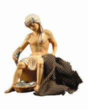 Fisher sitting on wooden case,  Nazarene