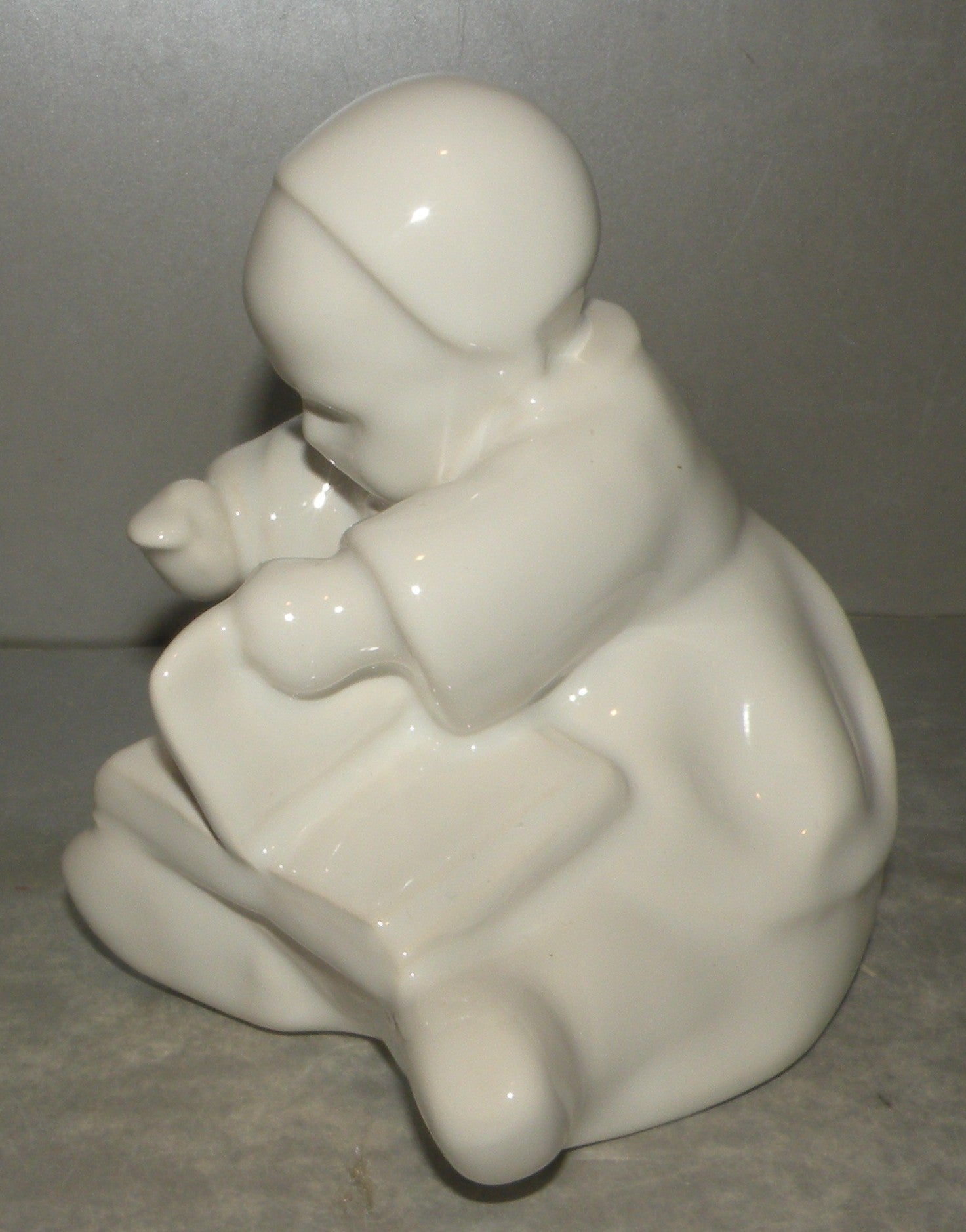 Baby with a book, white enamel- by Berthe Savigny, HB-Henriot