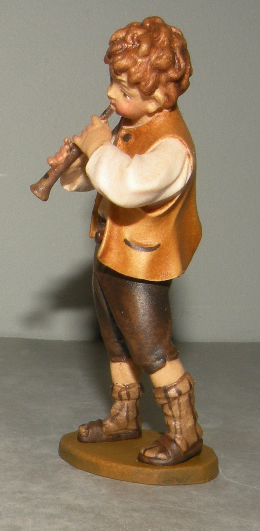 Child playing flute, Rustic