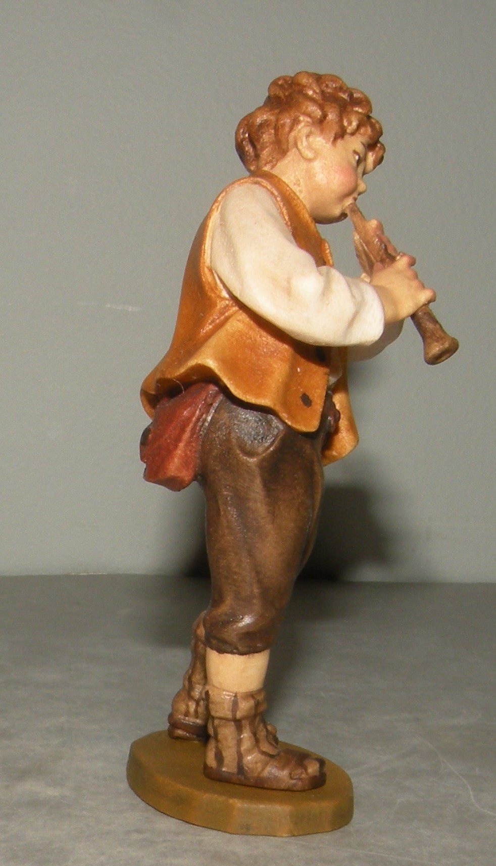 Child playing flute, Rustic