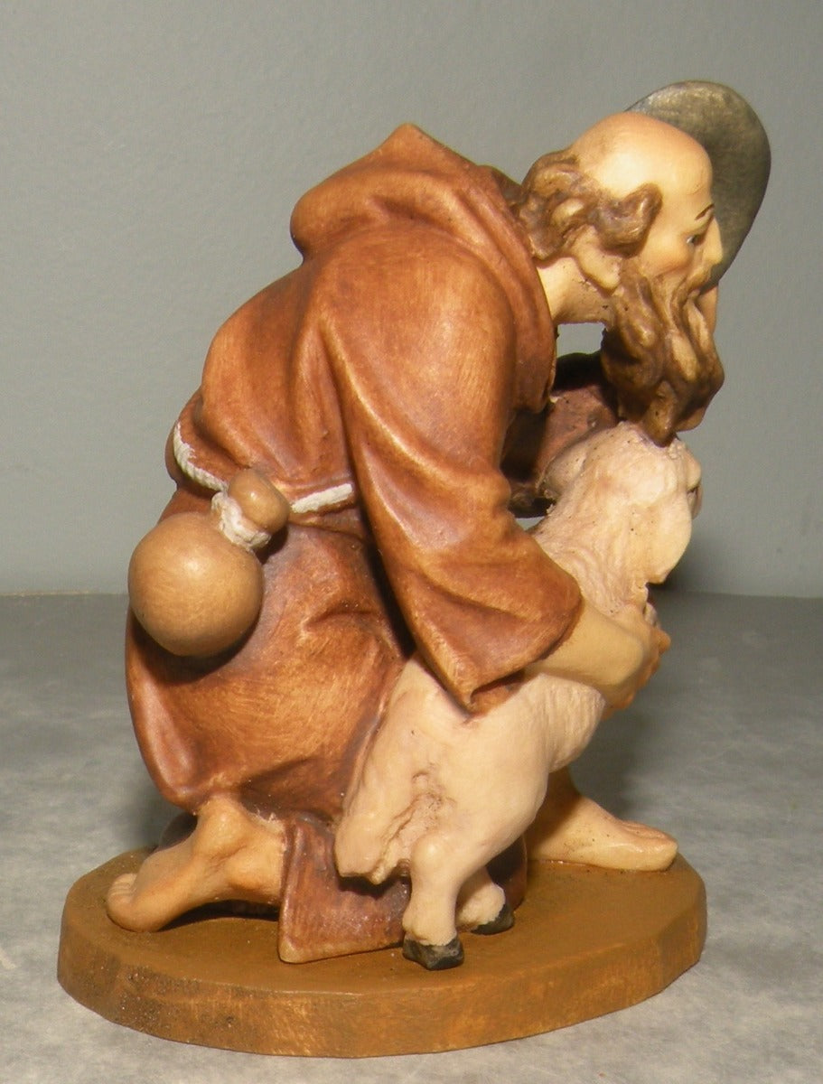 Shepherd kneeling with lamb , Lepi