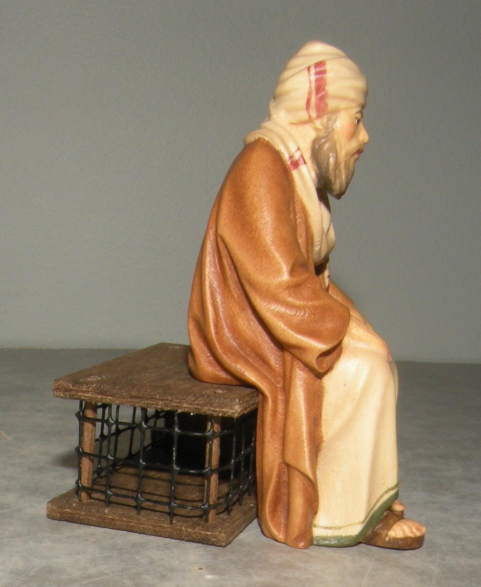 Shepherd sitting with cage , Lepi